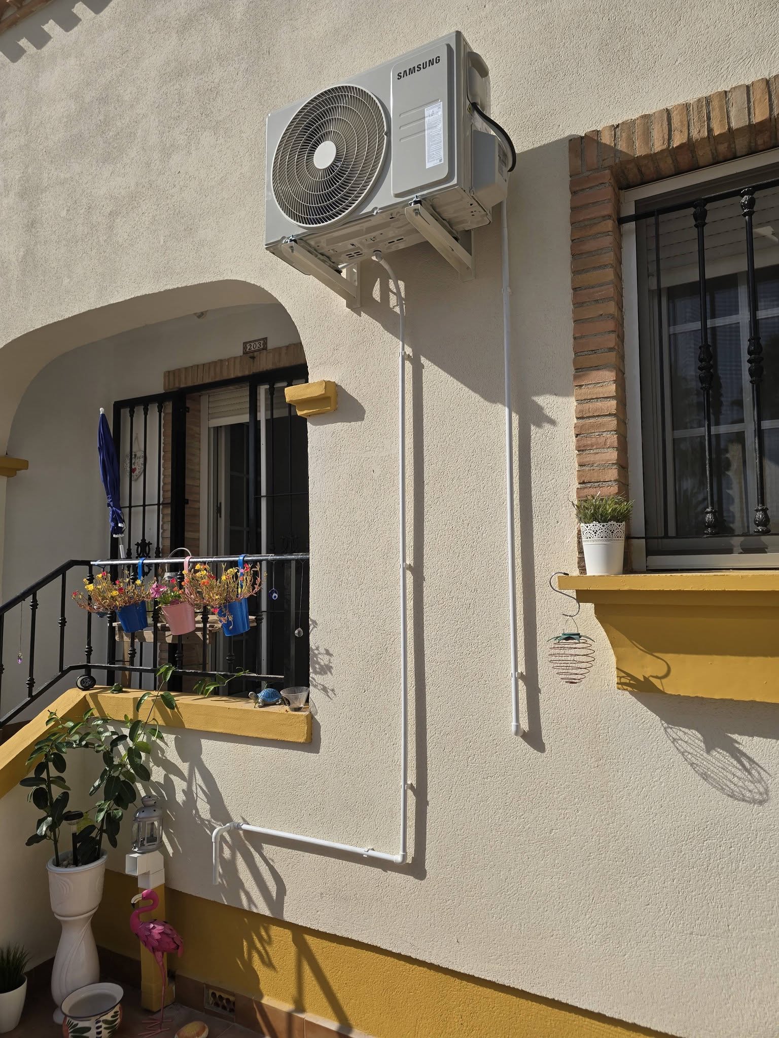 AC installation and refrigerant pressure testing on a Giatsu outdoor unit