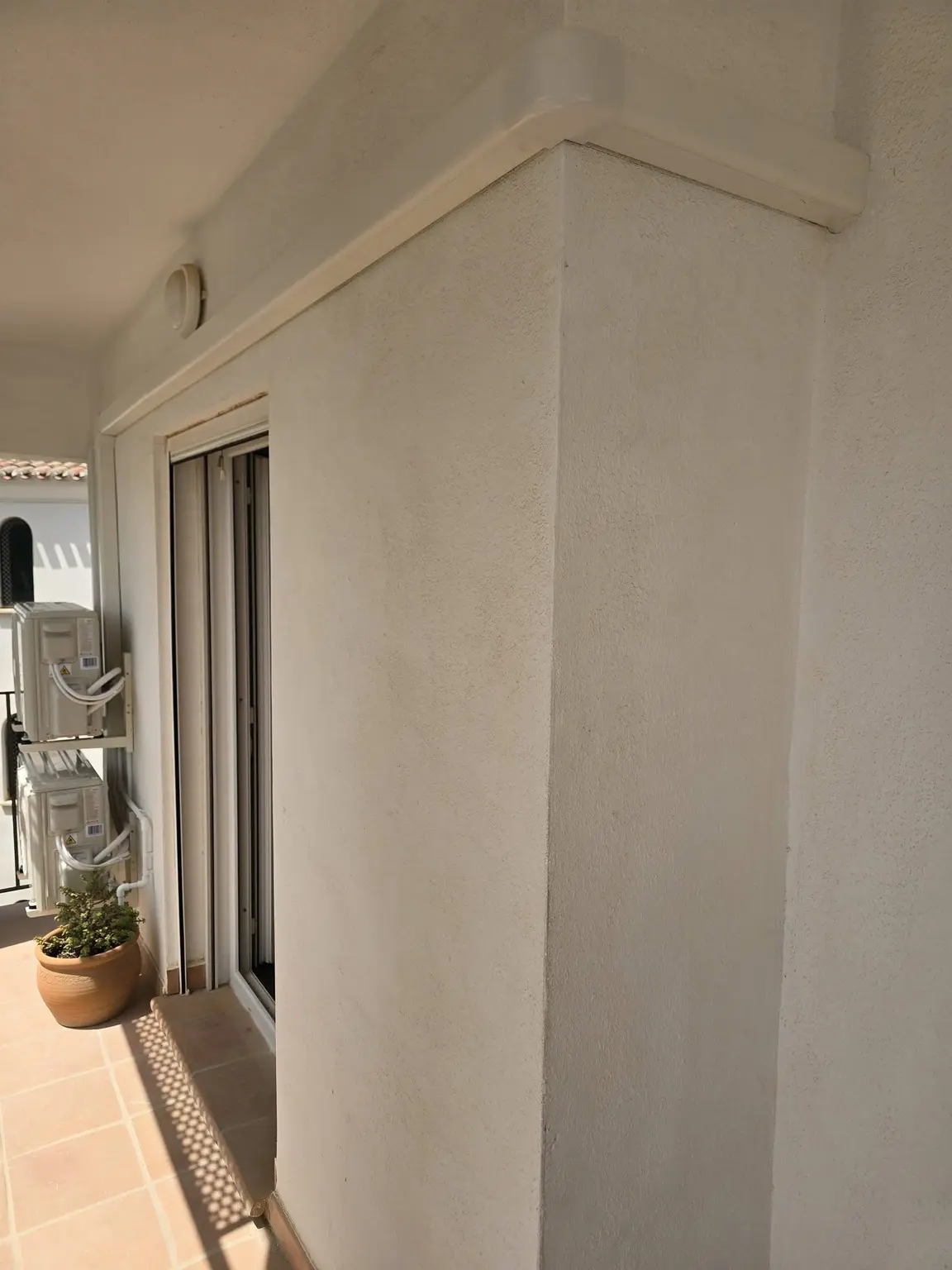 Neatly enclosed air conditioning pipework around a Costa Blanca property terrace